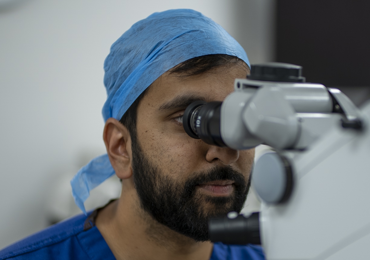 Mr Garg working at an operating microscope